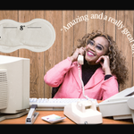 Woman in a pink jacket sitting at a desk with vintage phone and computer, with text about the size of Spicey heat patches.